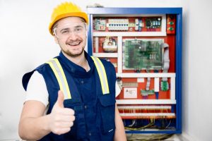 Young electrician Young happy electrician in Drayton, Portsmouth UK showing thumbs up